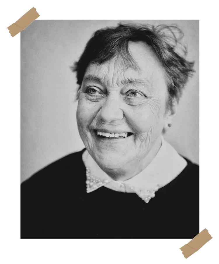 A heartfelt way to remember - A memorial book section featuring a smiling elderly woman in a black and white portrait, highlighting the importance of preserving memories and legacy.