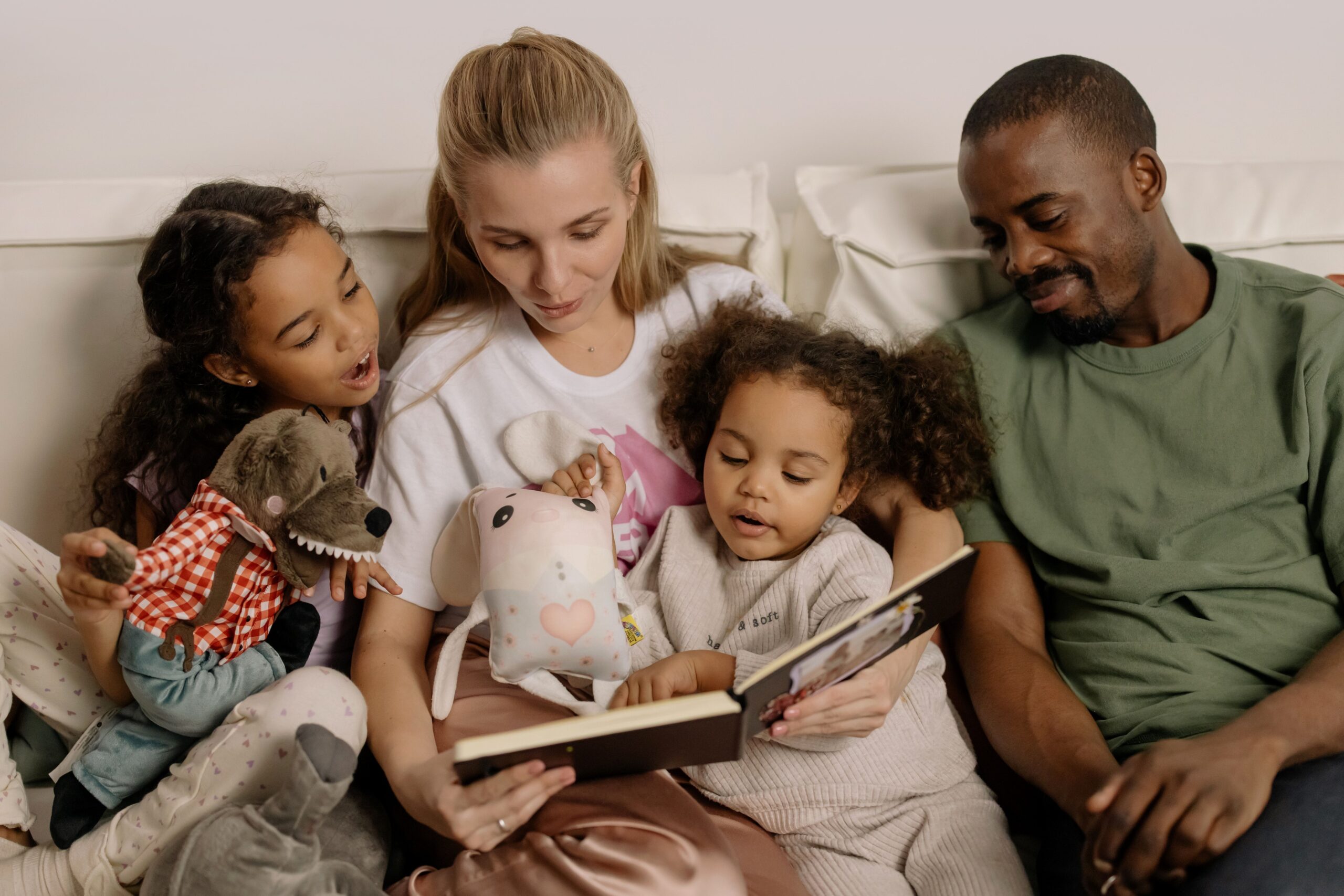A happy family of four reading their grandma book